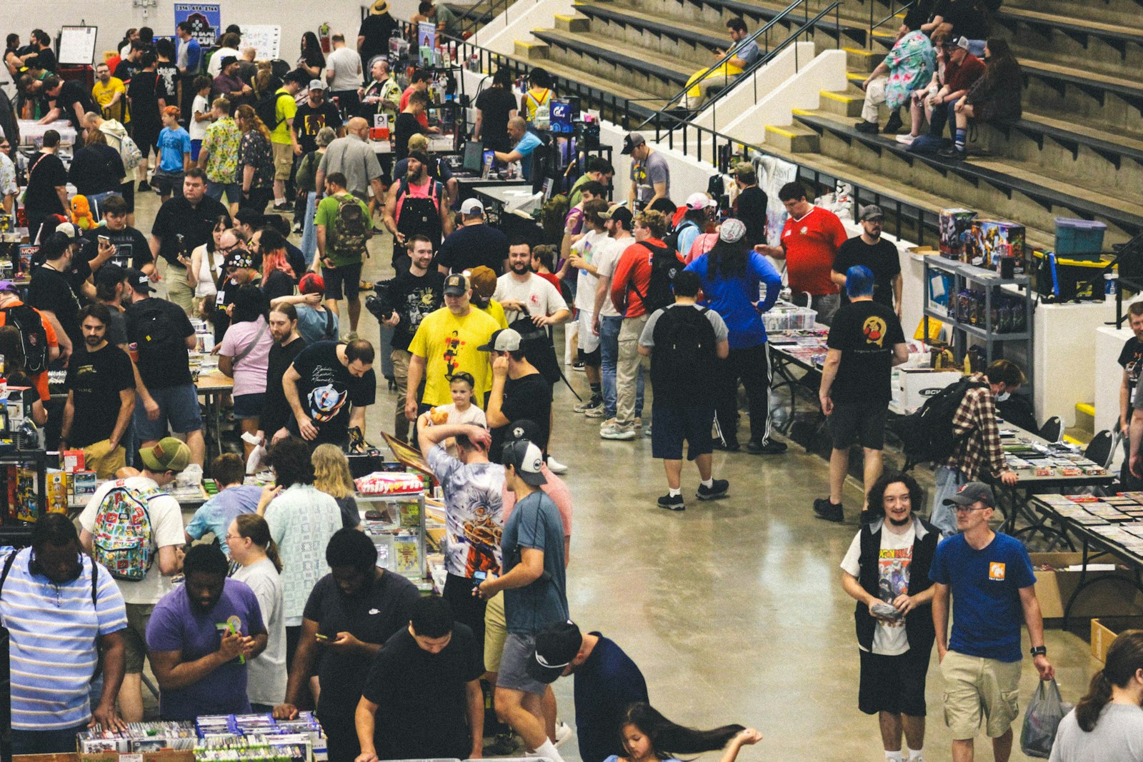 Large crowd of people at a bustling indoor convention.
